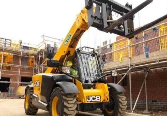 A yellow and black forklift is parked on the street